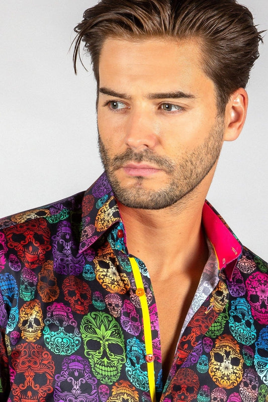 A man wearing a Claudio Lugli multicolored shirt with an ornamental skull pattern.