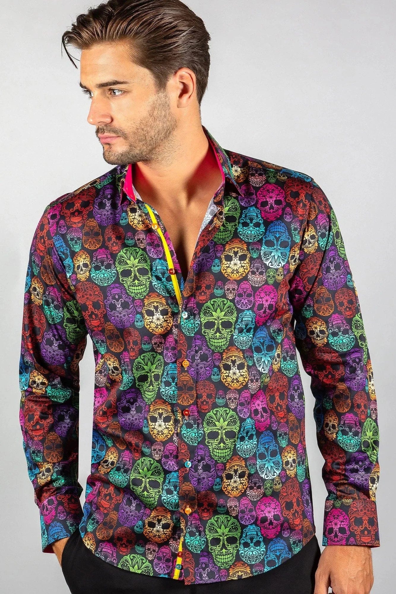 A man wearing a Claudio Lugli multicolored shirt with an ornamental skull pattern.
