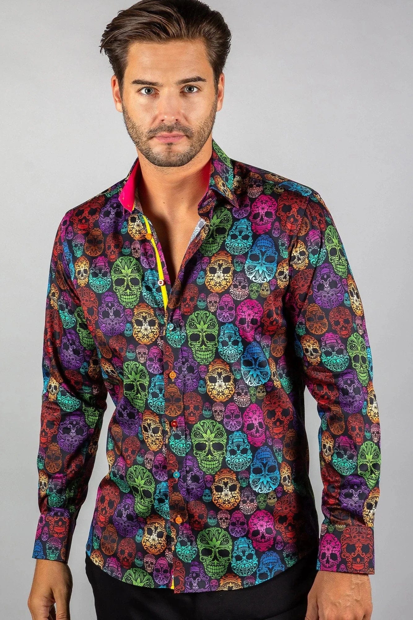 A man wearing a Claudio Lugli multicolored shirt with an ornamental skull pattern.