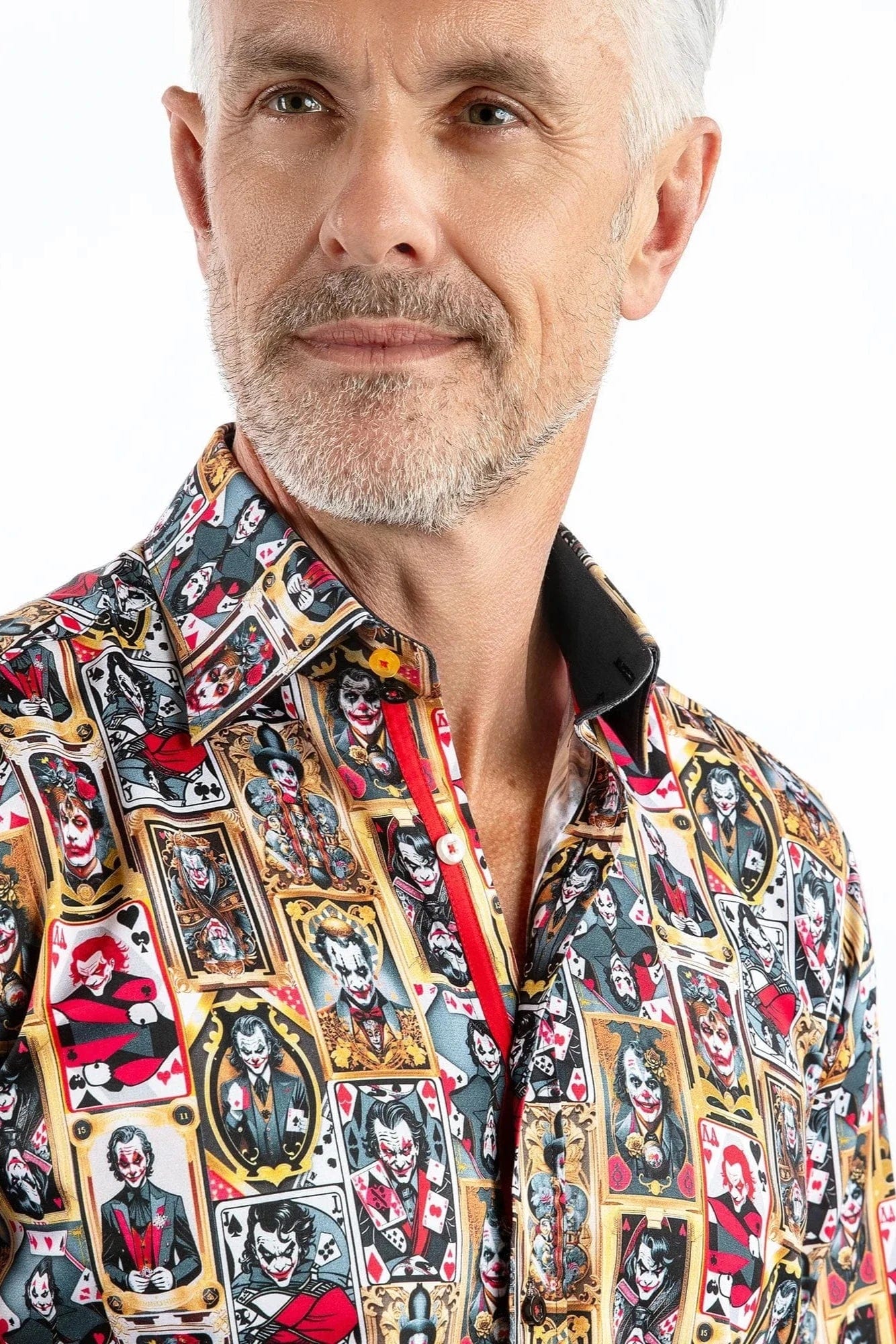 A man wearing a Claudio Lugli long-sleeve shirt with a bold joker-themed print in gold, red, and black, against a white background.