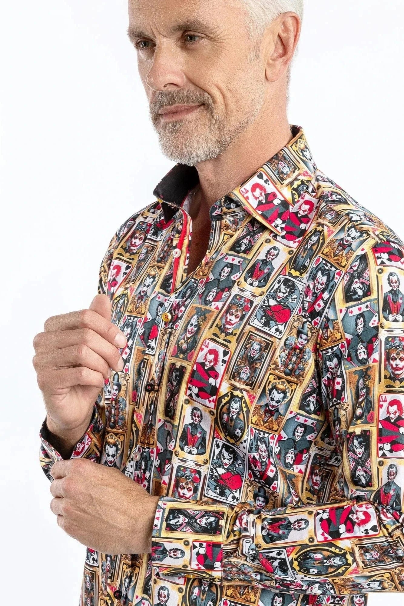 A man wearing a Claudio Lugli long-sleeve shirt with a bold joker-themed print in gold, red, and black.