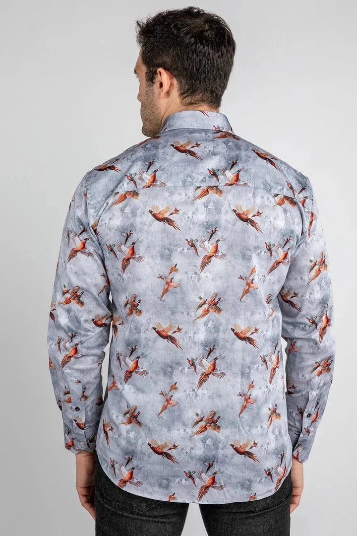 A man wearing a Claudio Lugli shirt with a pheasants flying print against a grey background.