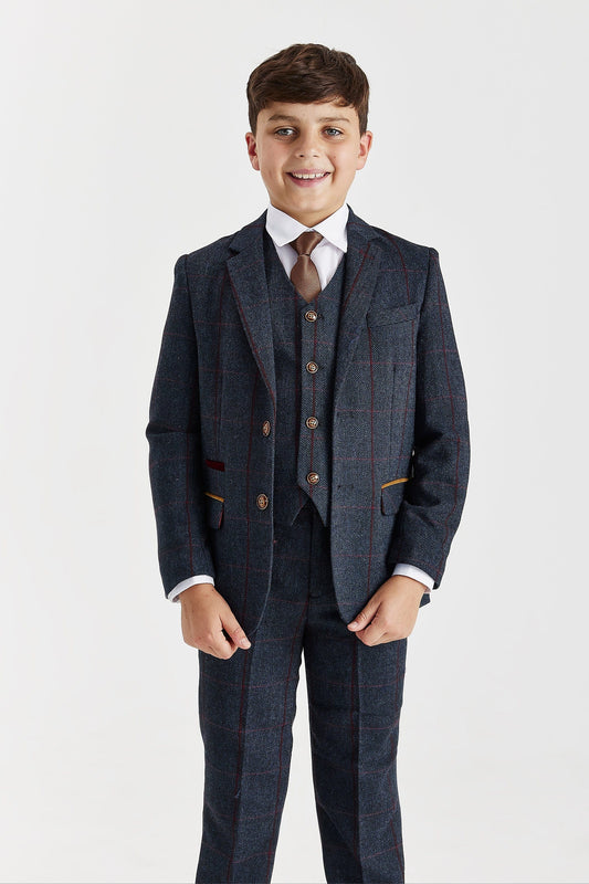 Young boy wearing a Paul Andrew Madrid navy tweed formal suit with a brown tie, perfect for weddings and matching father and son outfits, on a white background.