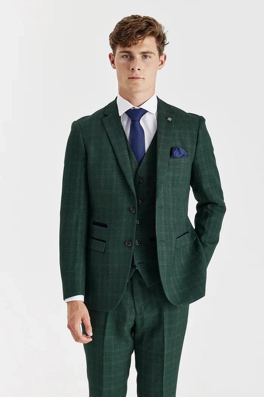 Man wearing a Paul Andrew Leo green checkered suit with a purple tie on a white background