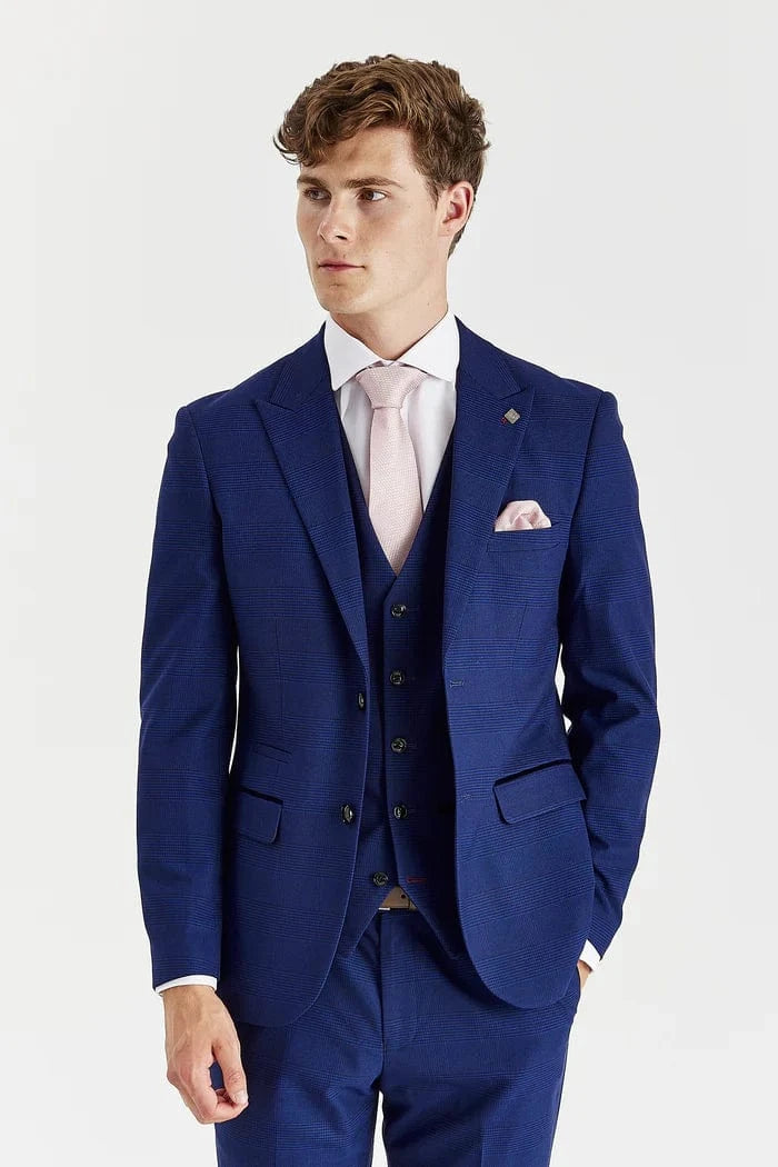 Man wearing a blue suit with a white shirt and pink tie on a white background