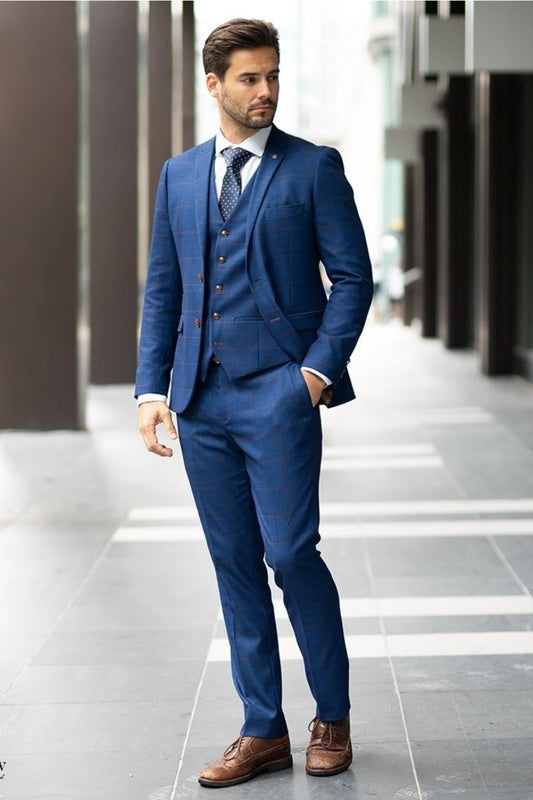 A man wearing a Paul Andrew Alex Blue three-piece suit Ideal for formal occasions and weddings.