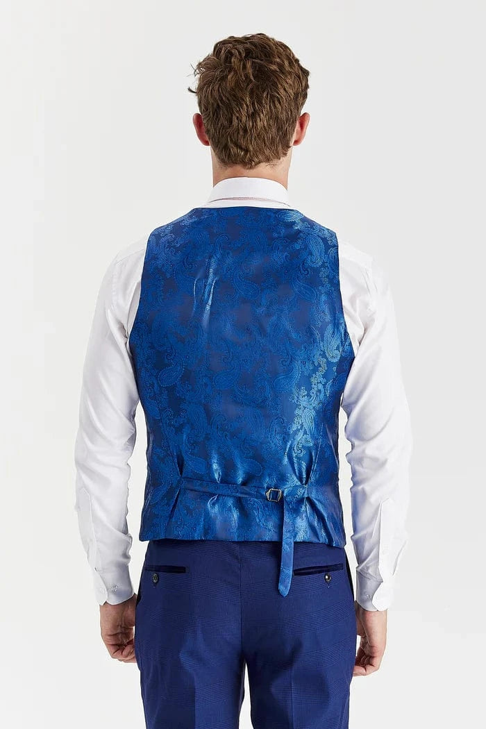 Man wearing a blue patterned vest over a white shirt on a white background