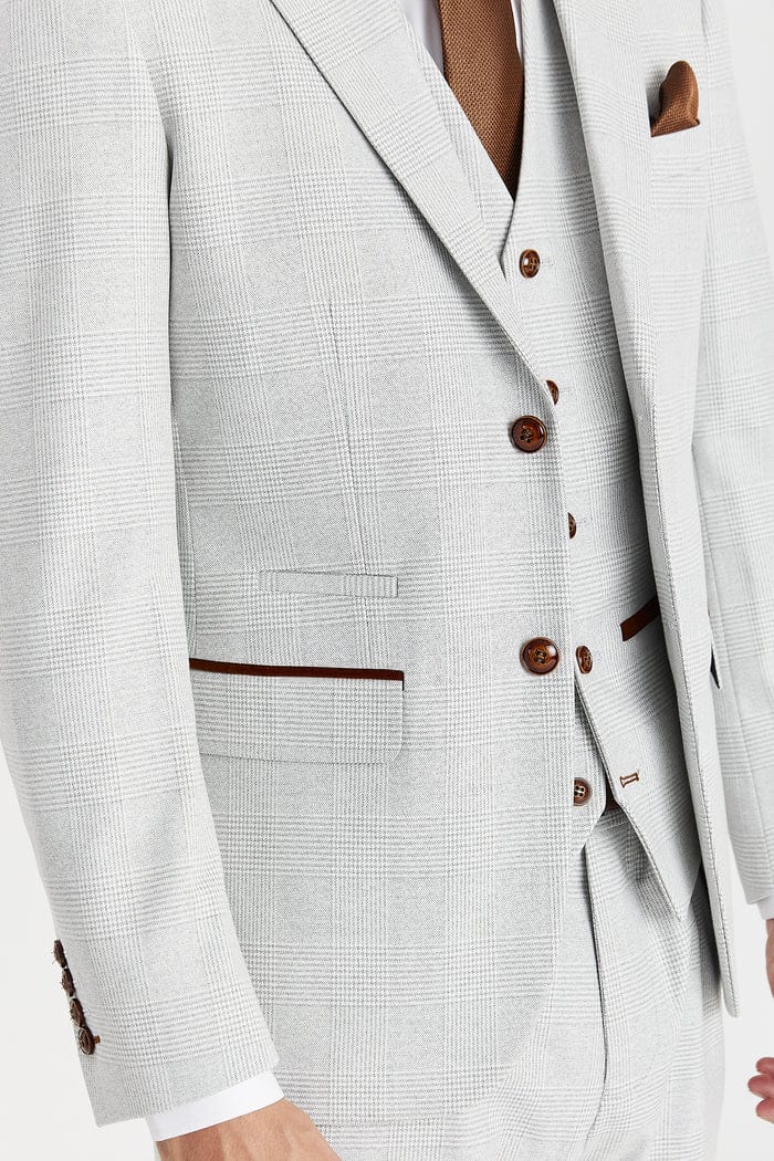 Stone checkered suit with brown buttons and trim on a neutral background