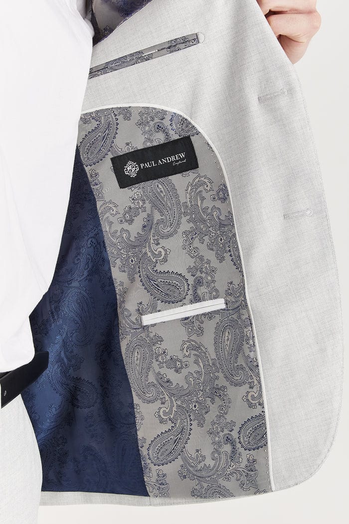 Inside view of the Paul Andrew Belmont Light Grey men’s suit jacket from Menz Suits Stockport, showing detailed navy and grey paisley lining.