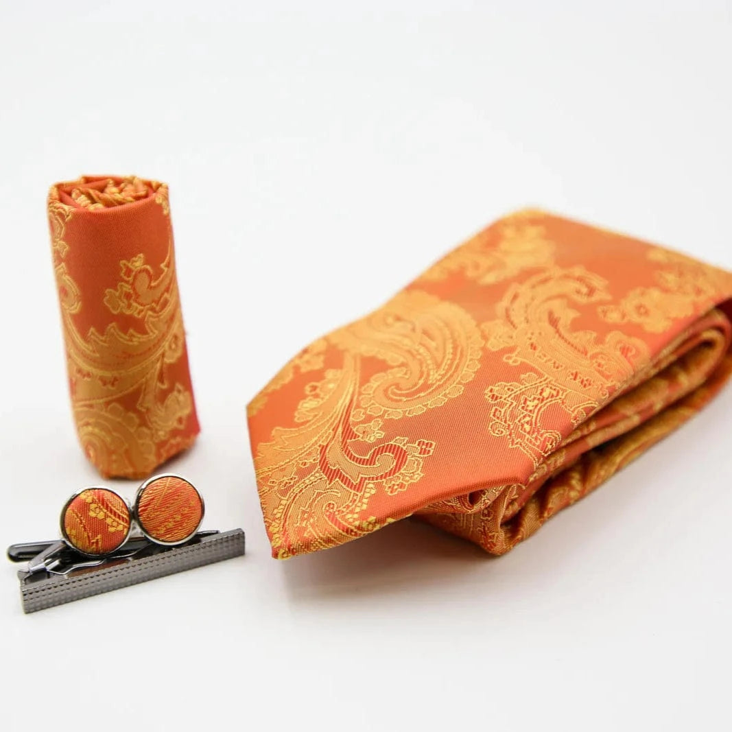 Paul Andrew orange paisley tie, cufflinks, and tie clip on a white background