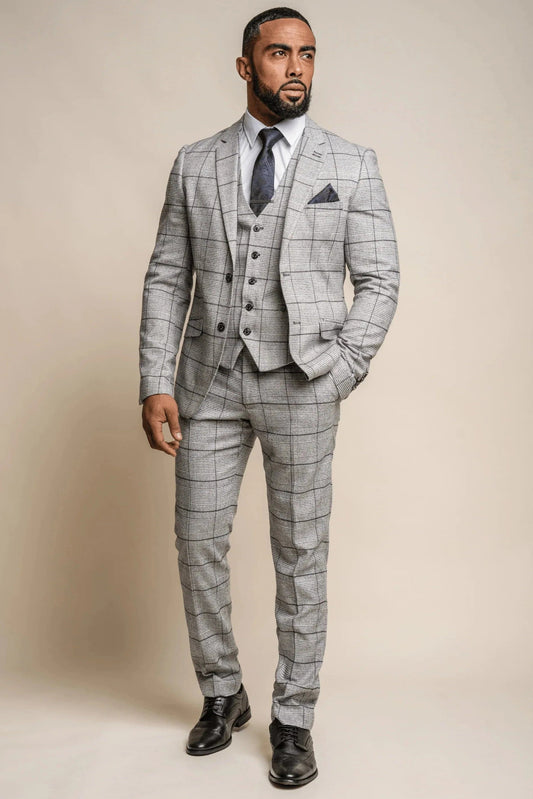A man modeling a Cavani Ghost Grey Check 3-Piece Suit, featuring a jacket, waistcoat, and trousers with a subtle checkered pattern.