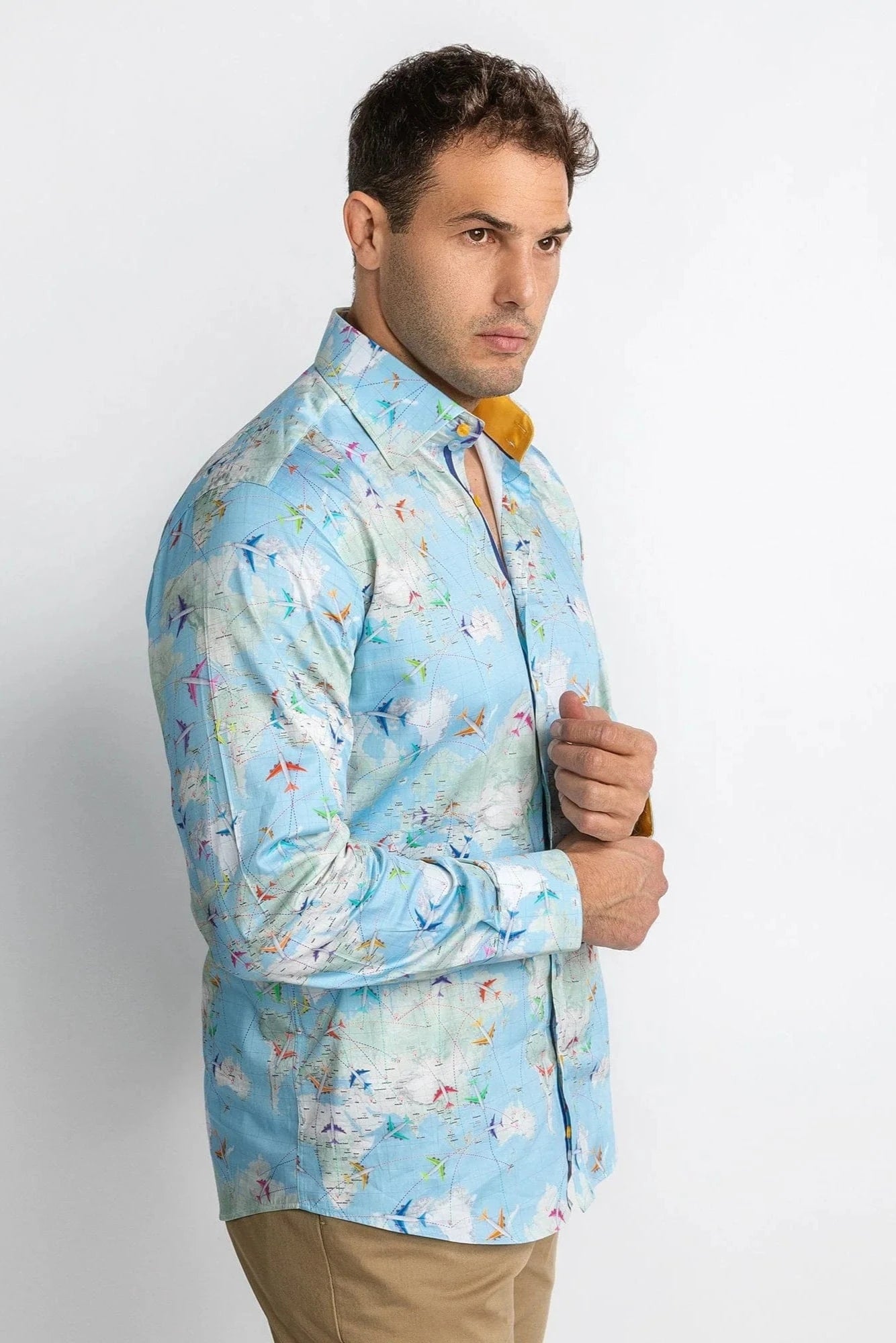 Man wearing a light blue patterned shirt against a white background