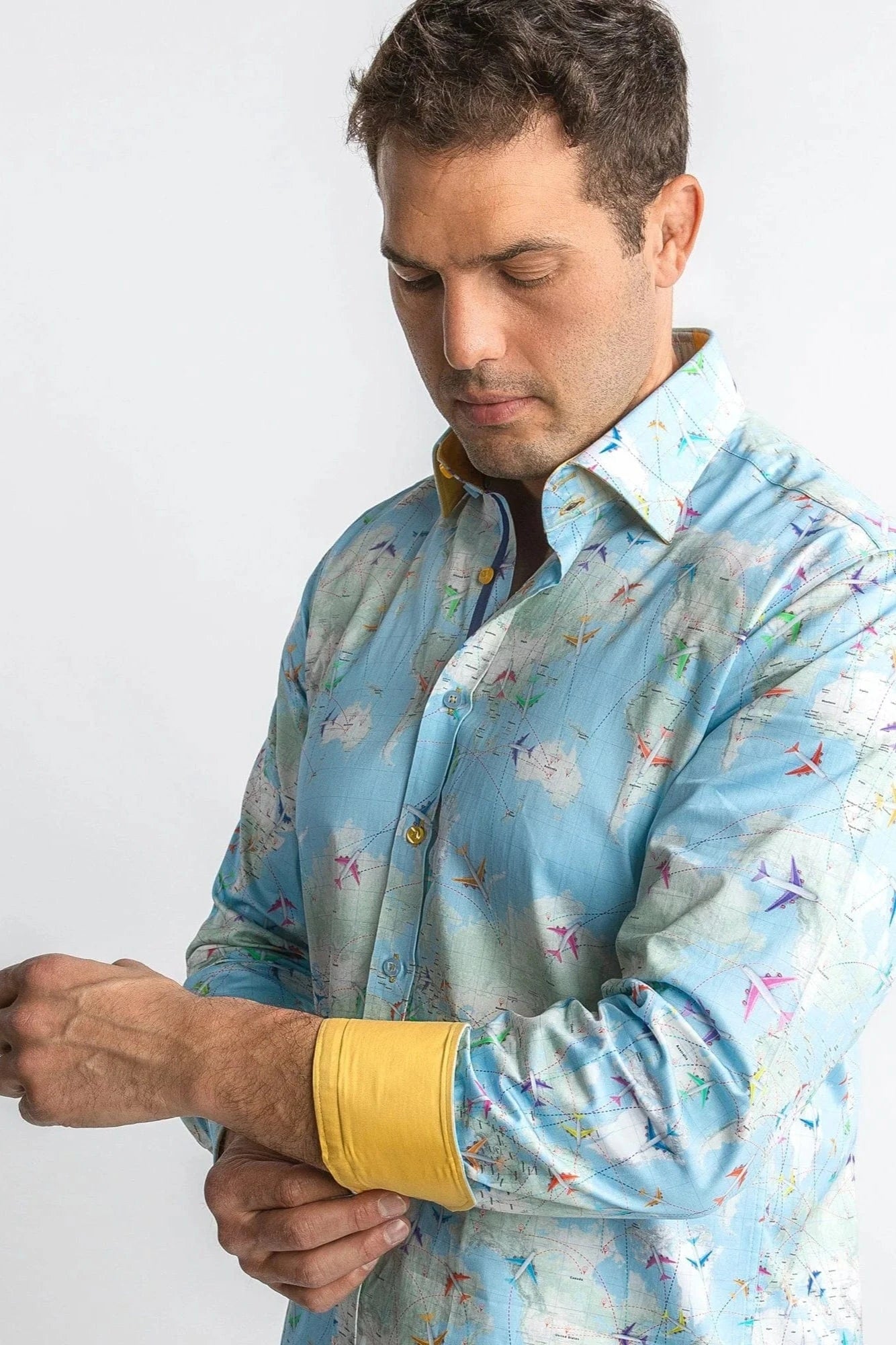 Man wearing a colorful patterned shirt with a plain background