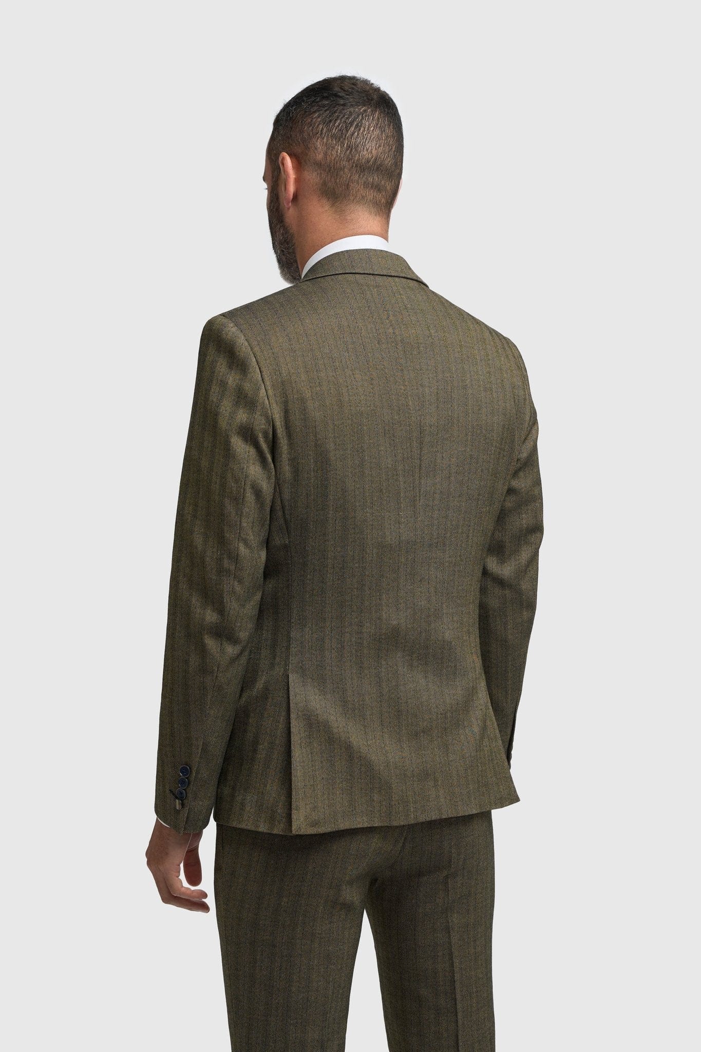 Man wearing a Cavani Damon Sage Tweed suit on a white background