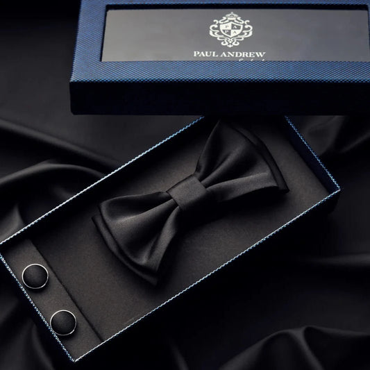 Paul Andrew black bow tie and cufflinks set in a Paul Andrew box on black fabric