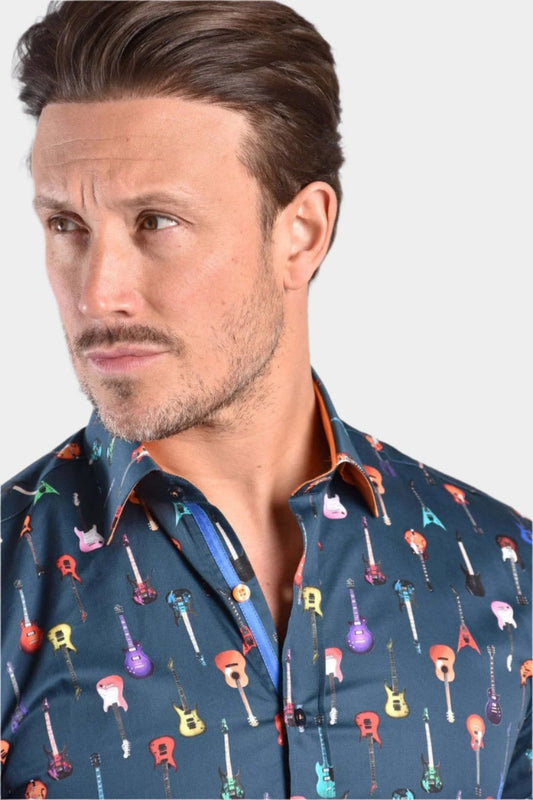 A man wearing a navy Claudio Lugli shirt with a guitars pattern, against a white background.