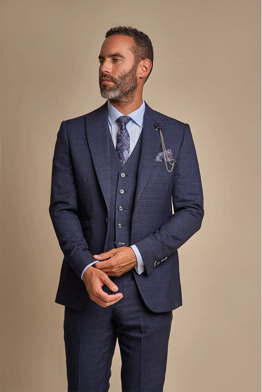 Man wearing the Caridi Navy Three Piece Suit with a tailored fit and structured silhouette. Ideal men’s formal suit for weddings, business, and events. Front view