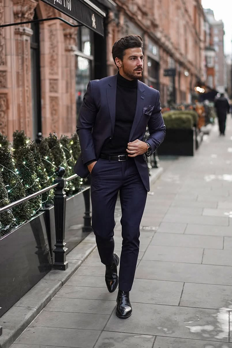 Man in a navy suit walking on a city street