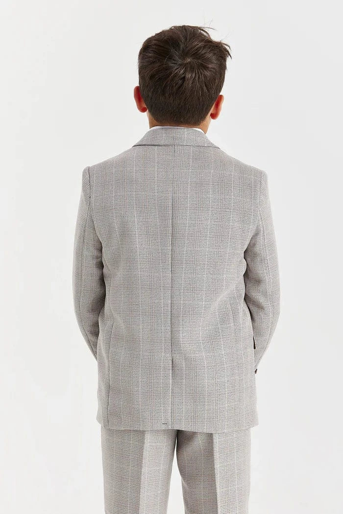 Back view of a person wearing a beige checkered suit on a white background