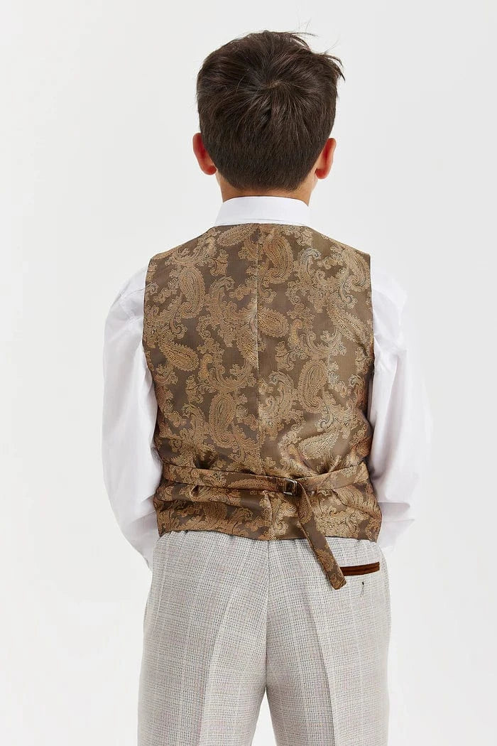 Person wearing a patterned vest over a white shirt and light-colored pants on a white background