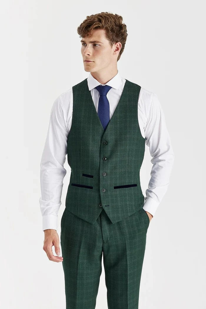 Man wearing a green checkered suit with a blue tie on a white background