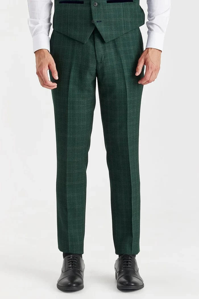 Green checkered suit pants worn by a person on a white background