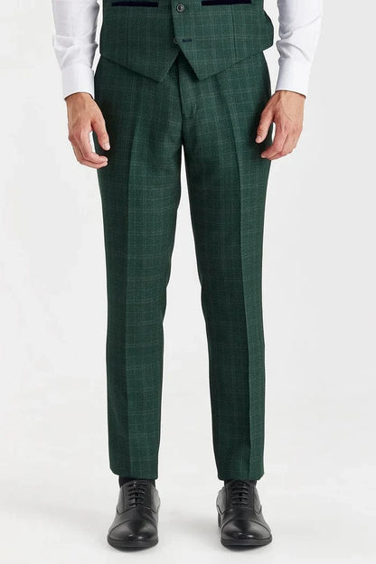 Green checkered suit pants worn by a person on a white background