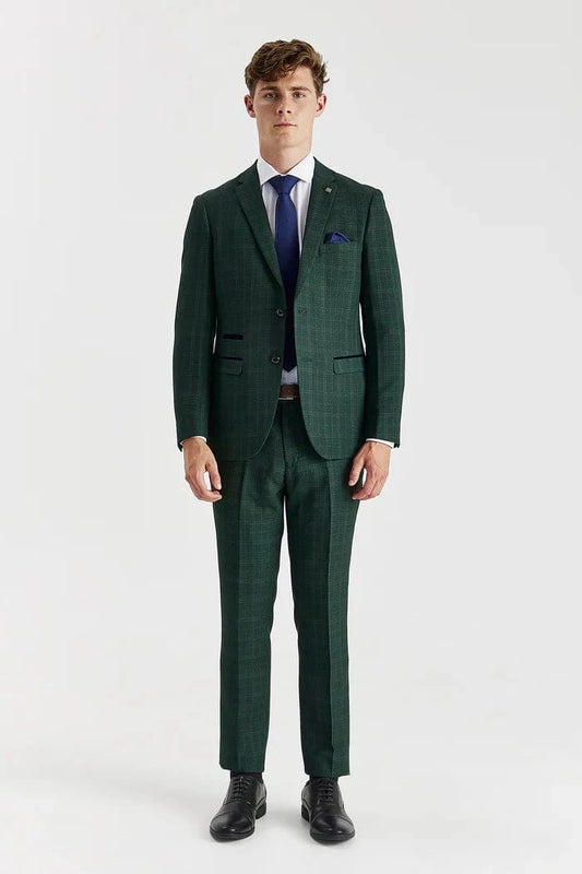 Man wearing a green checkered suit with a blue tie on a white background