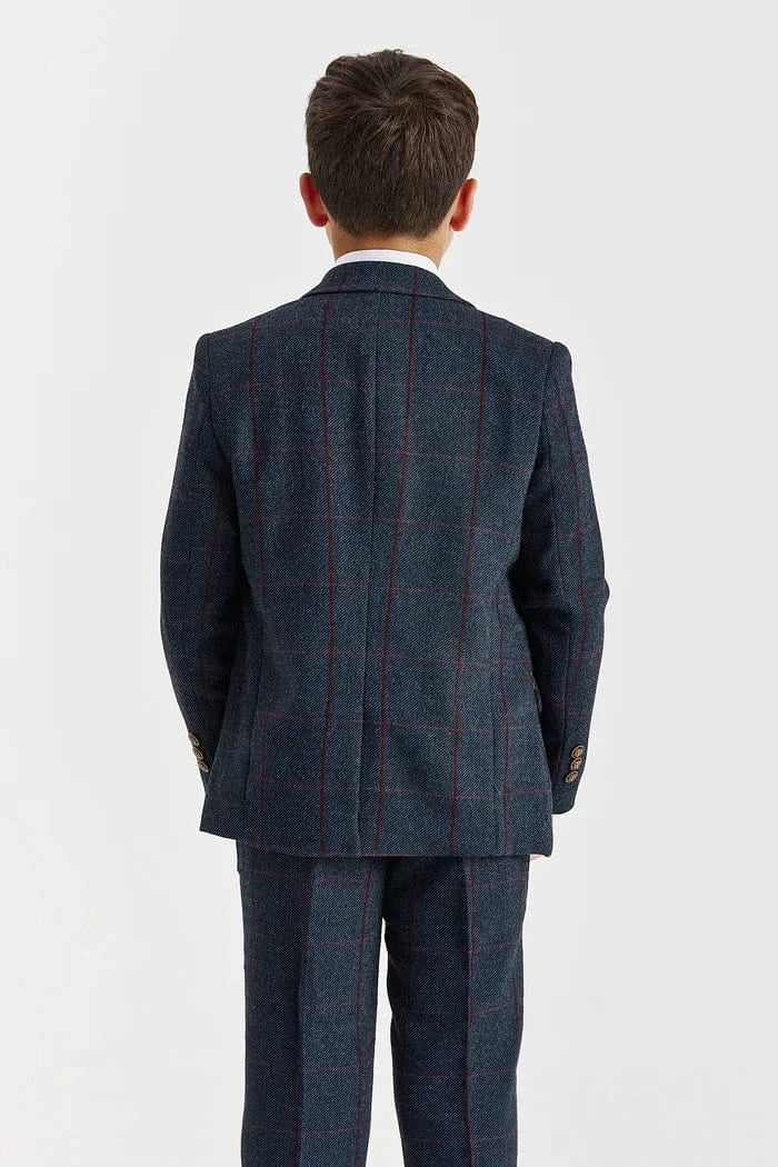 Back view of a child wearing a navy checkered suit on a white background