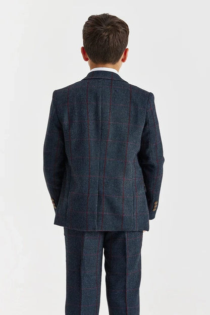 Back view of a child wearing a navy checkered suit on a white background