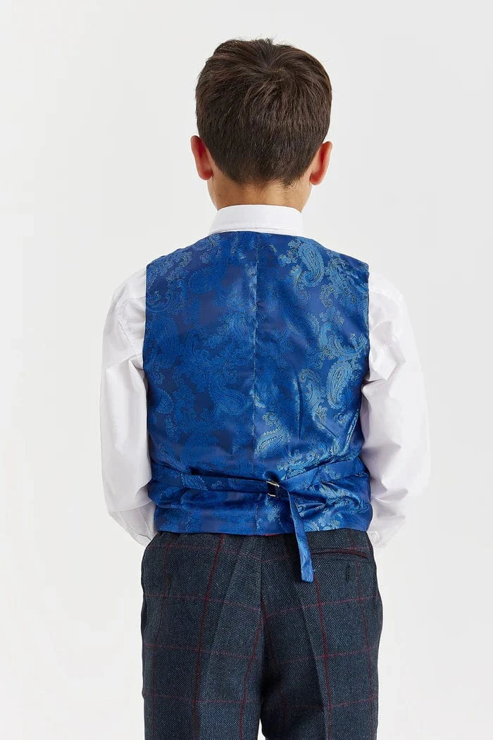 Child wearing a blue vest over a white shirt on a white background