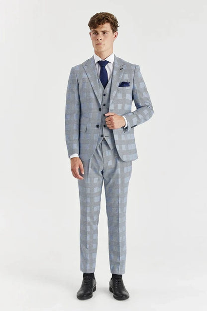 Man wearing a Paul Andrew sky blue checkered suit with a white shirt and black shoes on a white background