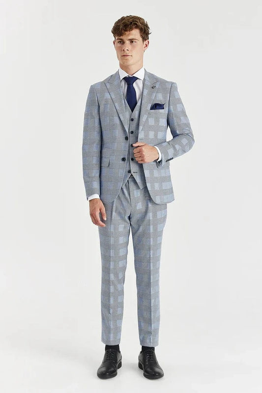 Man wearing a Paul Andrew sky blue checkered suit with a white shirt and black shoes on a white background