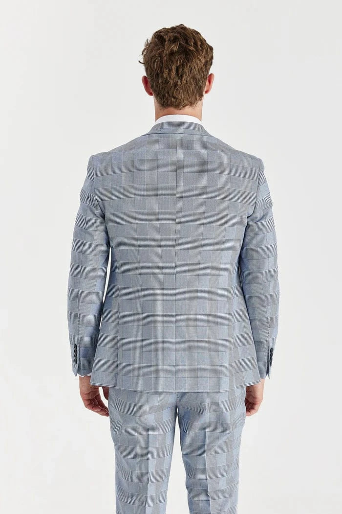 Man wearing a Paul Andrew sky blue checkered suit with a white shirt on a white background