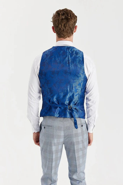 A person back wearing a waistcoat blue paisley design over a white shirt and sky blue checkered pants on a white background