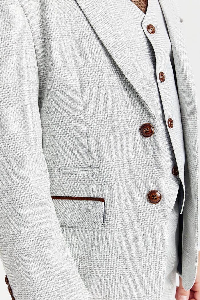 Close-up of a stone checkered suit jacket with brown buttons.