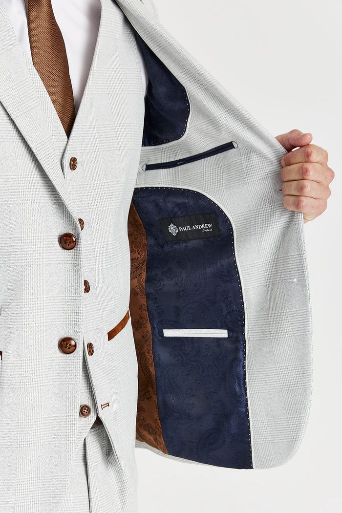Close-up of a suit jacket with a brand label on a white background