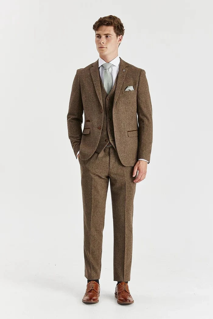 Man wearing a Paul Andrew Oscar brown tweed suit with a white shirt and brown shoes on a white background