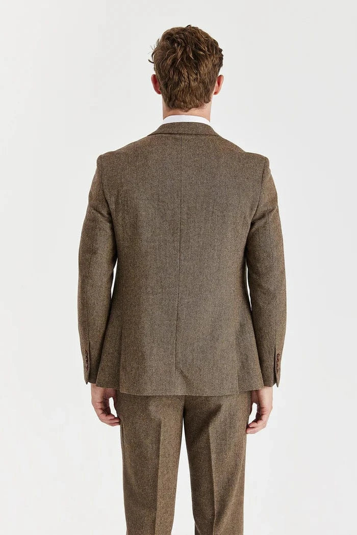 Man wearing a Paul Andrew brown tweed suit on a white background