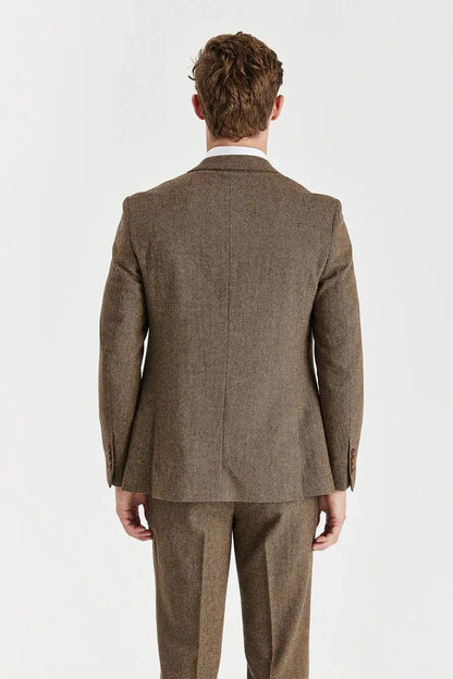 Man wearing a Paul Andrew brown tweed suit on a white background