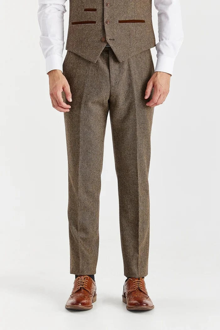 Man wearing a brown tweed suit with a white shirt on a white background