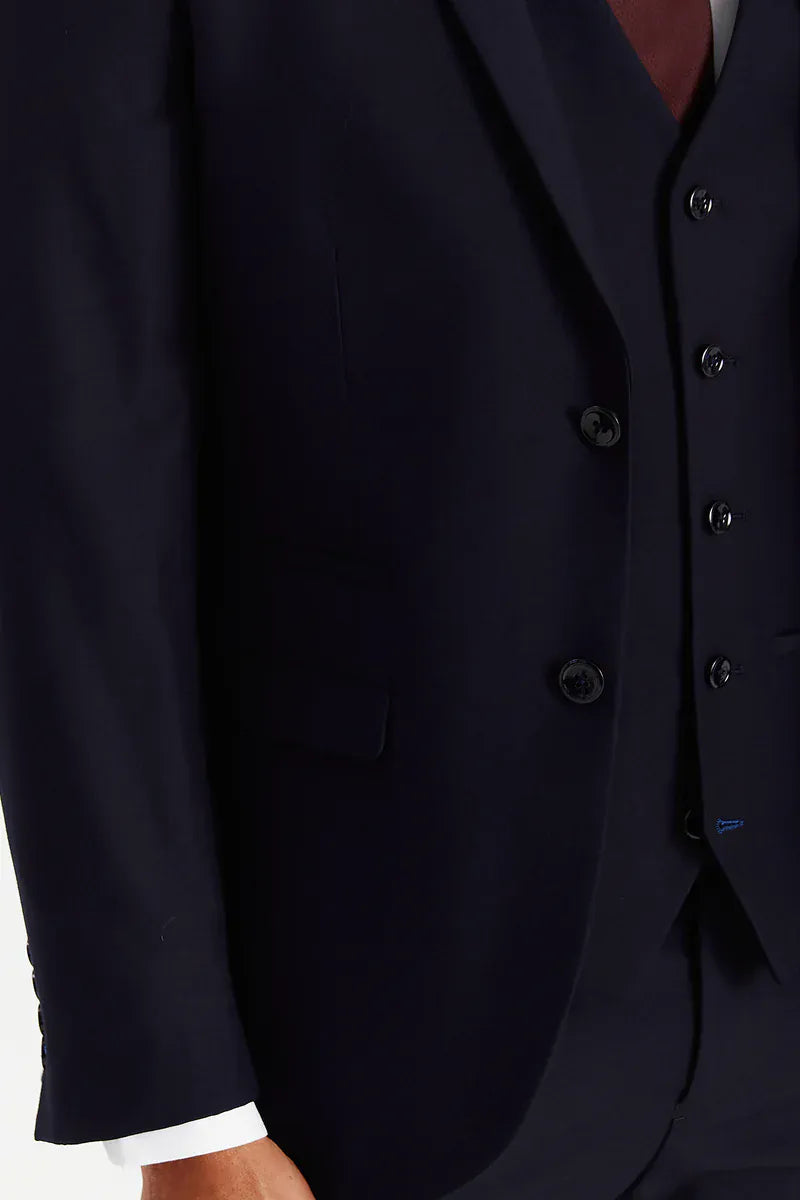 Close-up of the navy suit jacket showing the black buttons and plain fabric.