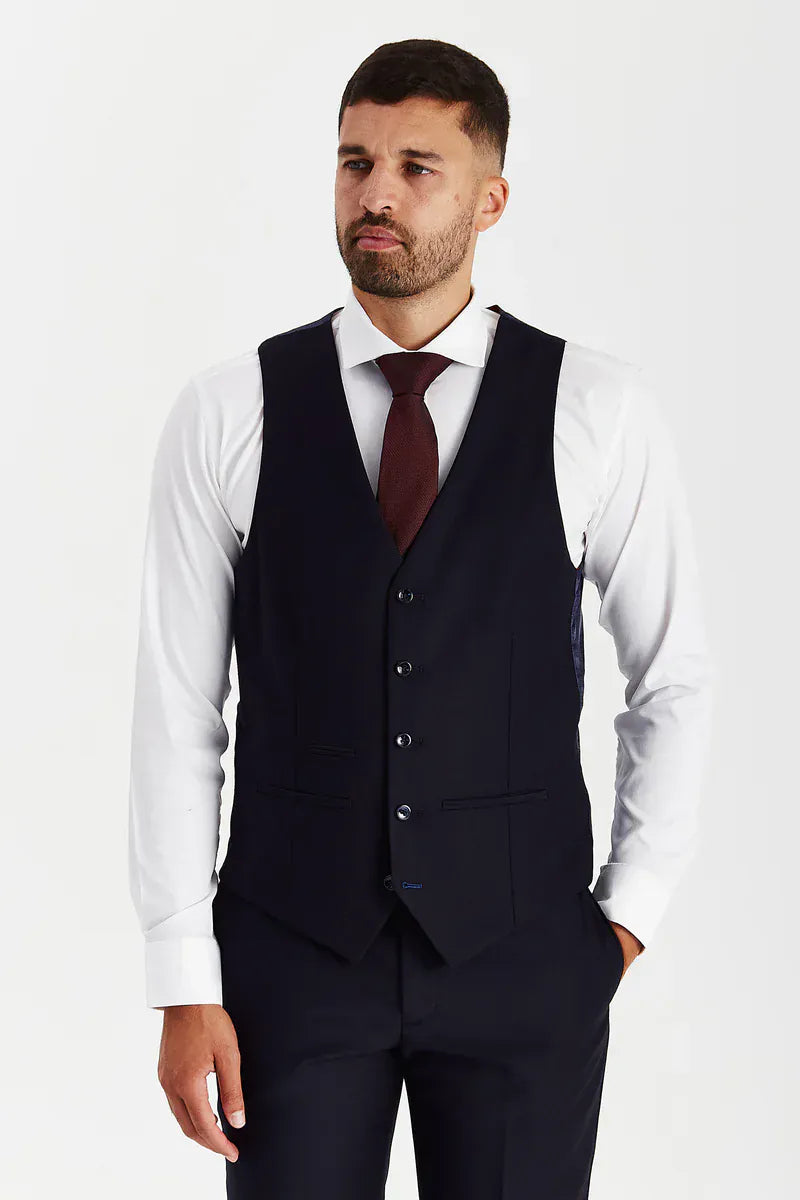 Front view of the Paul Andrew Parker Navy men’s waistcoat from Menz Suits Stockport, featuring matching navy fabric and black button detail.