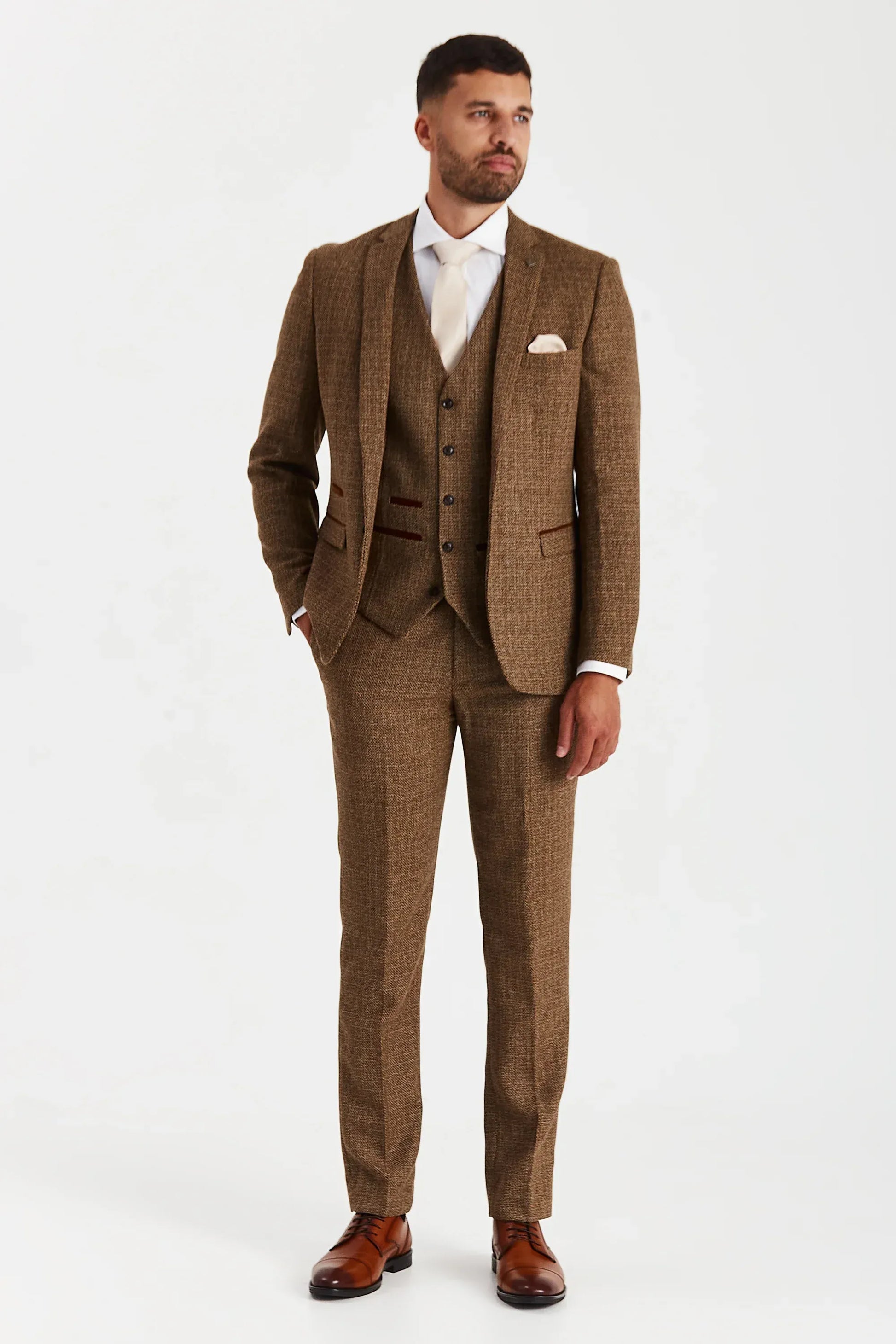 Male model wearing the Paul Andrew Ralph Brown Tweed 1920s Style Three Piece men’s suit from Menz Suits Stockport, featuring rich brown tweed fabric and suede trimmings.