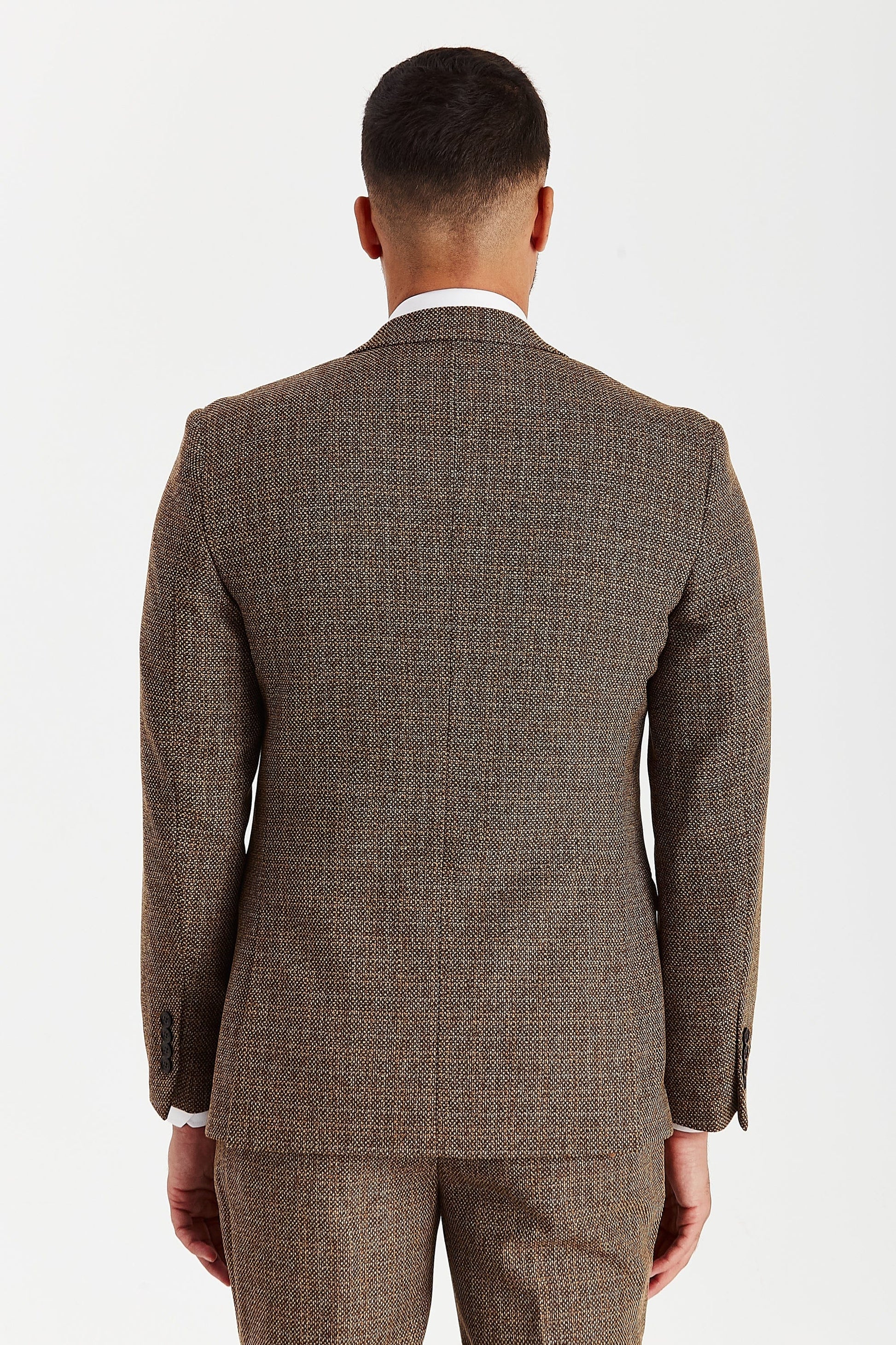 Rear view of a male model wearing the Paul Andrew Ralph Brown Tweed 1920s Style men’s suit from Menz Suits Stockport, highlighting double vents and classic tweed pattern.
