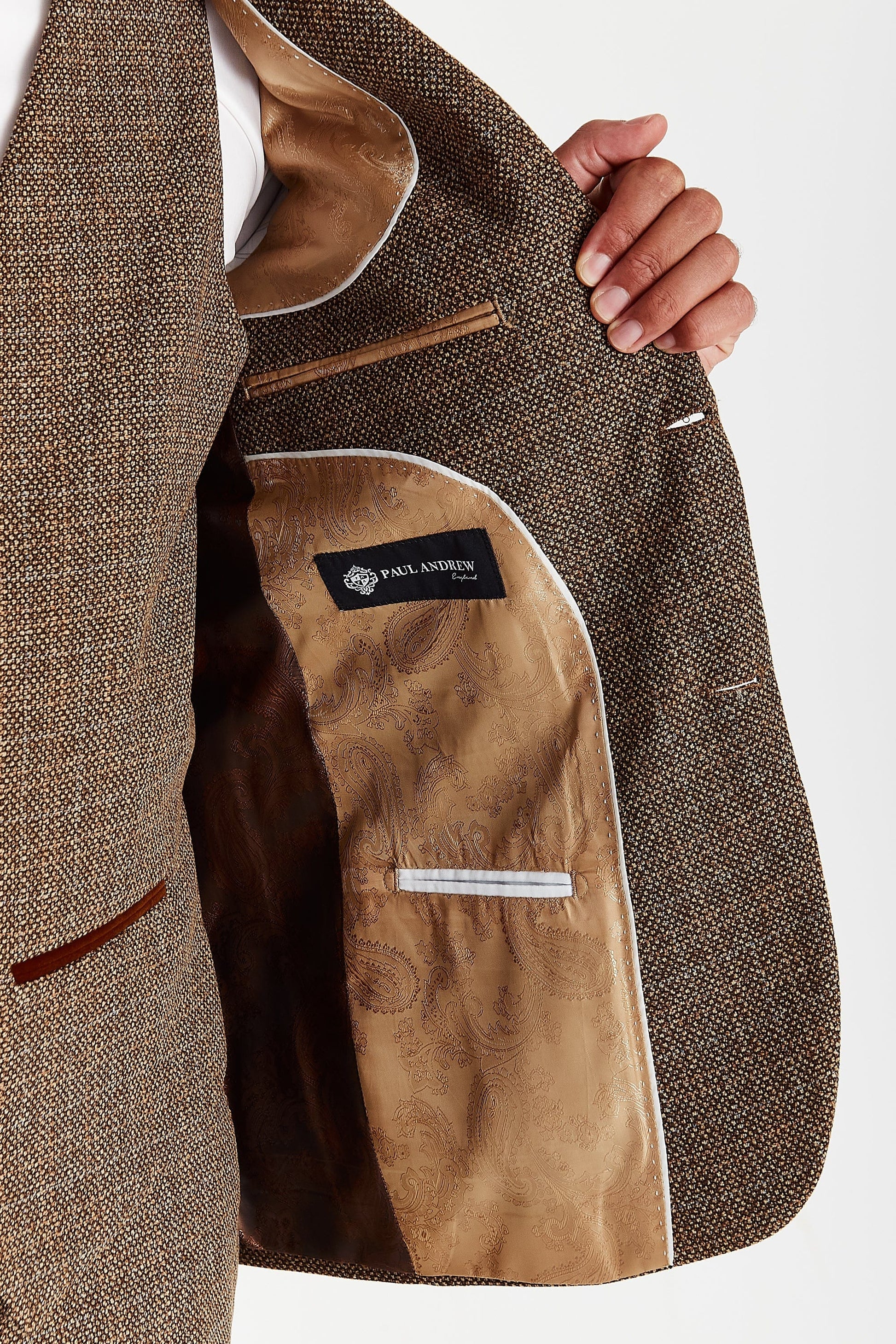 Inside view of the Paul Andrew Ralph Brown Tweed Three Piece men’s suit from Menz Suits Stockport, featuring brown and gold paisley lining and detailed stitching.