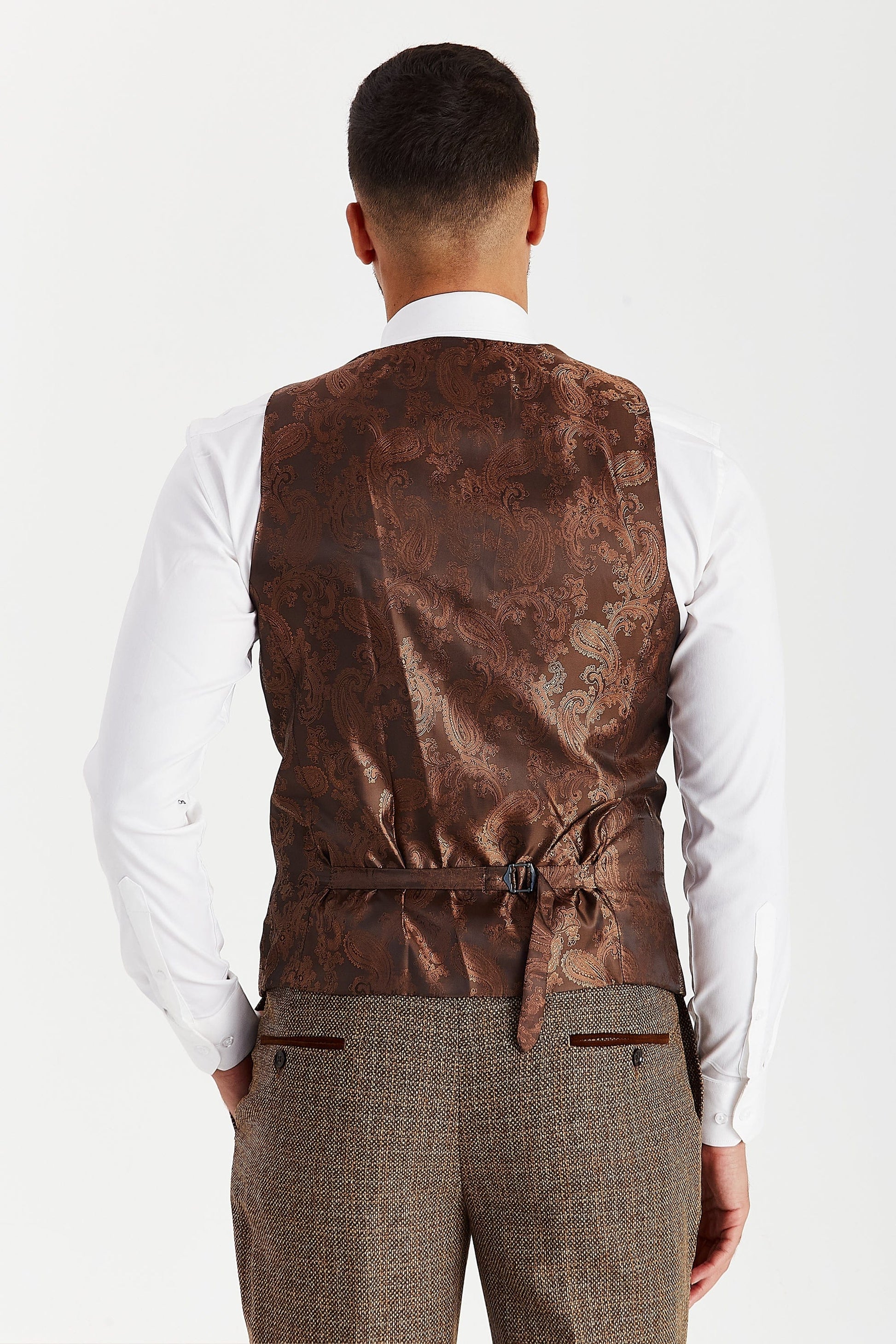 Rear view of the Paul Andrew Ralph Brown Tweed men’s waistcoat from Menz Suits Stockport, featuring adjustable back strap and brown paisley finish.