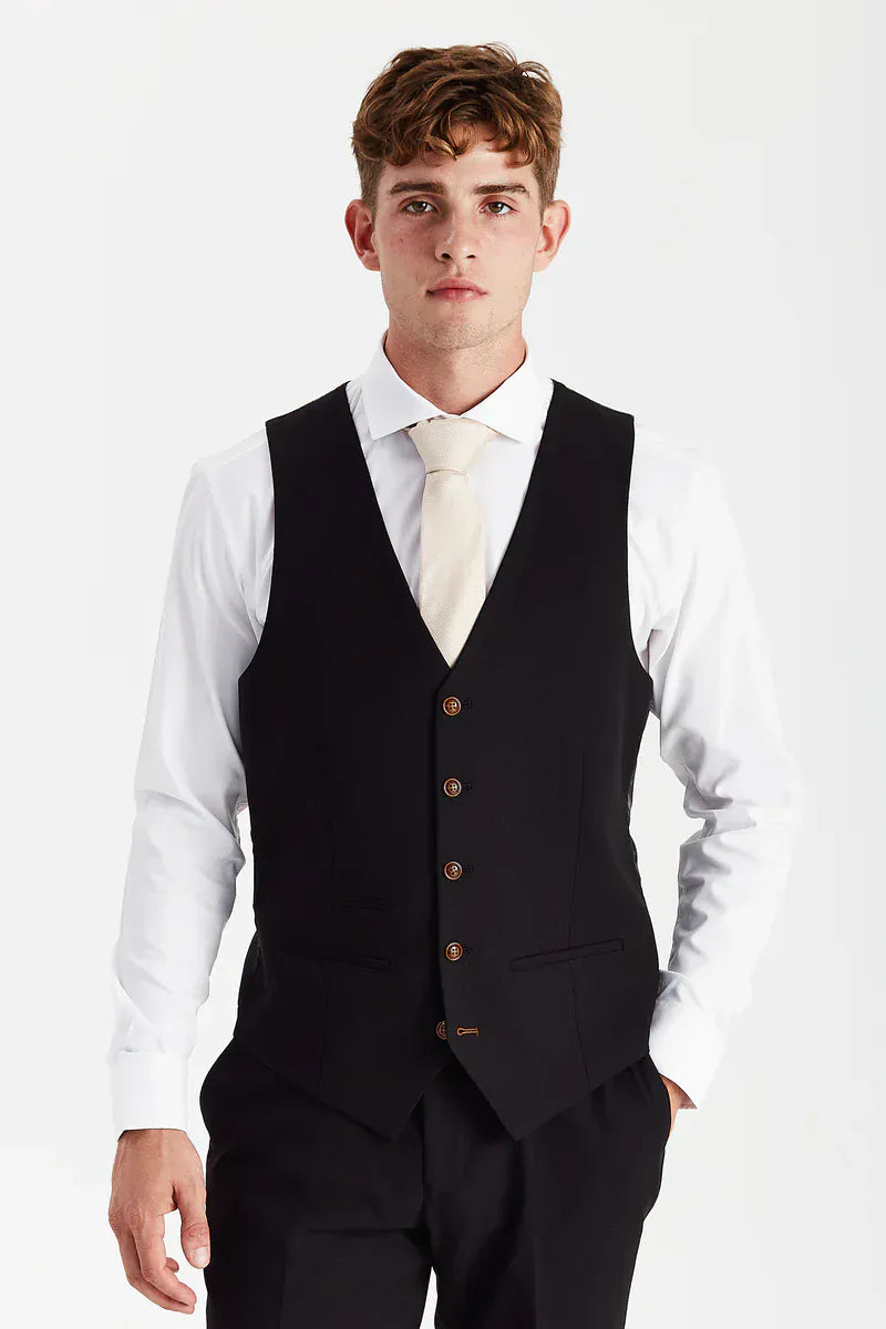 Front view of the Paul Andrew Mayfair Black men’s waistcoat from Menz Suits Stockport, featuring matching black fabric and contrasting brown buttons.