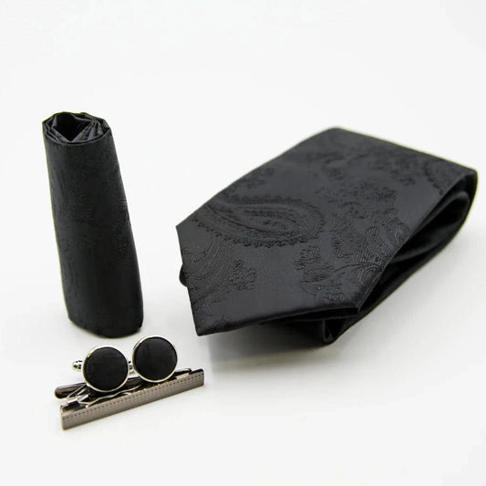 Paul Andrew black tie, cufflinks, and tie clip on a white background