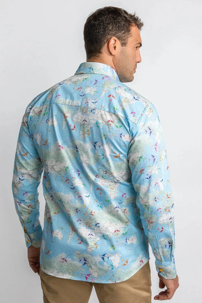 Man wearing a light blue patterned shirt on a plain background